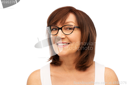 Image of portrait of senior woman in glasses over white