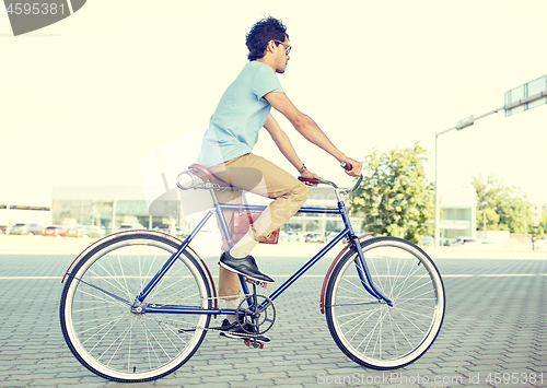 Image of young hipster man riding fixed gear bike