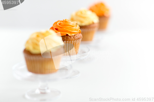 Image of cupcakes with frosting on confectionery stands