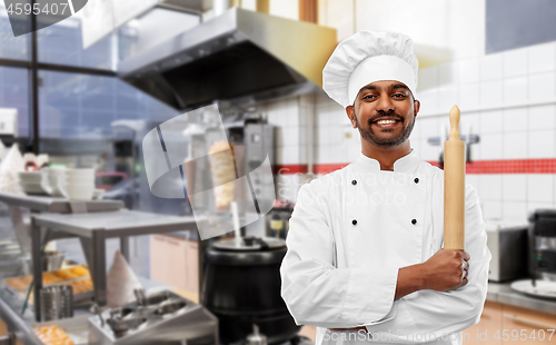 Image of happy indian chef with rolling-pin at kebab shop