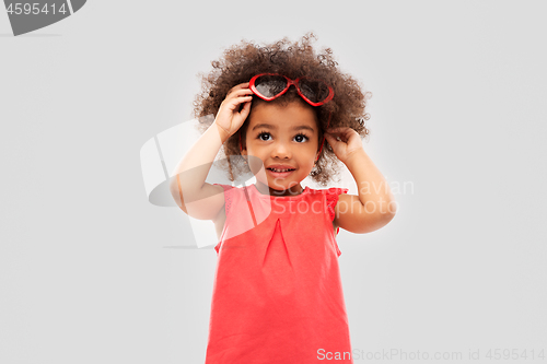 Image of african ameican girl with heart shaped sunglasses