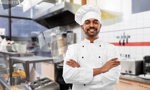 Image of happy male indian chef in toque at kebab shop