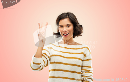 Image of happy smiling woman showing three fingers