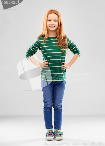 Image of smiling red haired girl posing in striped shirt