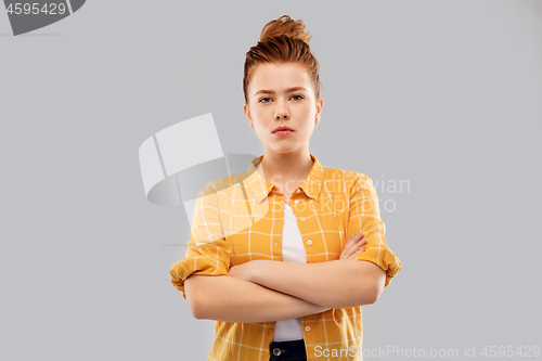 Image of serious red haired teenage girl with crossed arms