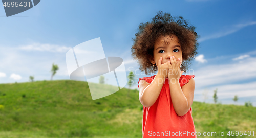 Image of confused african american girl covering mouth