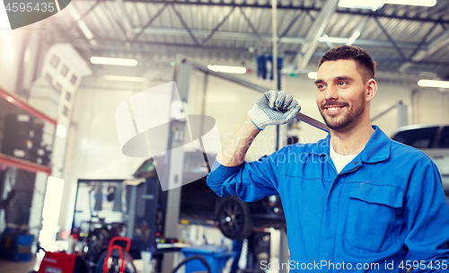 Image of auto mechanic or smith with wrench at car workshop