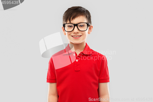 Image of portrait of smiling boy in glasses and red t-shirt