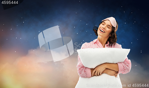 Image of woman with pillow in pajama and eye sleeping mask