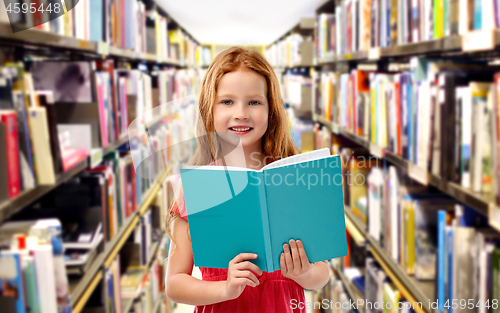 Image of smiling red haired girl reading book at library