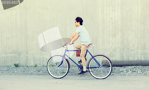 Image of young hipster man riding fixed gear bike