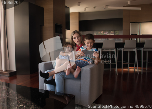 Image of happy young mother spending time with kids