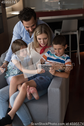 Image of happy young couple spending time with kids