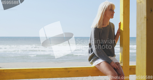 Image of Young woman enjoying the warm autumn day