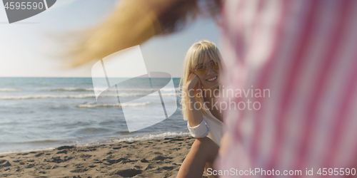 Image of Two girl friends having fun photographing each other on vecation