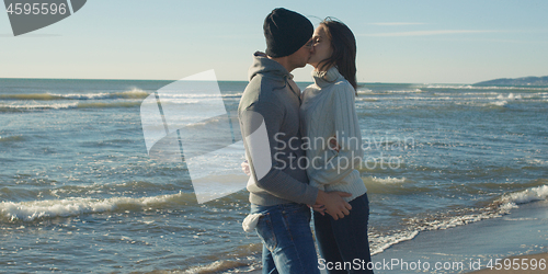 Image of Couple having fun on beautiful autumn day at beach