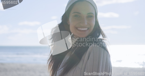 Image of Girl In Autumn Clothes Smiling on beach