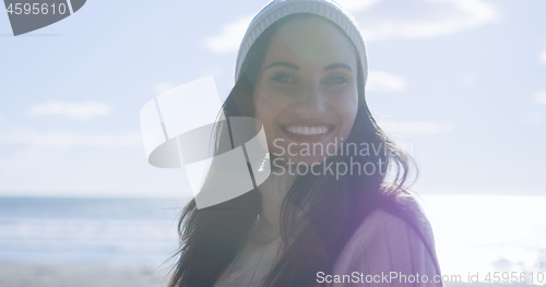 Image of Girl In Autumn Clothes Smiling on beach