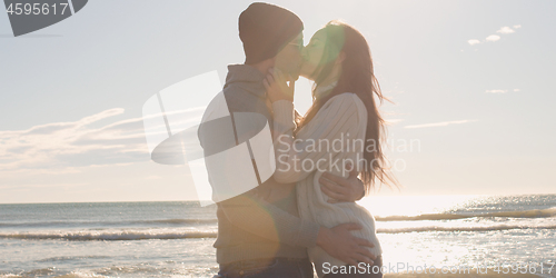 Image of Couple having fun on beautiful autumn day at beach