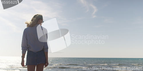 Image of Young woman enjoying the warm autumn day