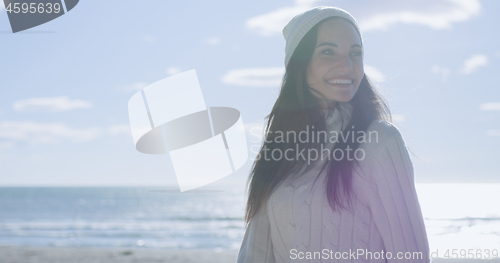 Image of Girl In Autumn Clothes Smiling on beach