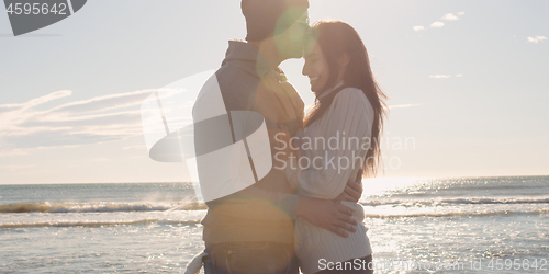 Image of Couple having fun on beautiful autumn day at beach