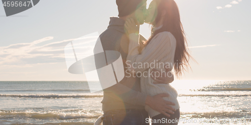 Image of Couple having fun on beautiful autumn day at beach