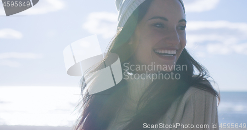 Image of Girl In Autumn Clothes Smiling on beach