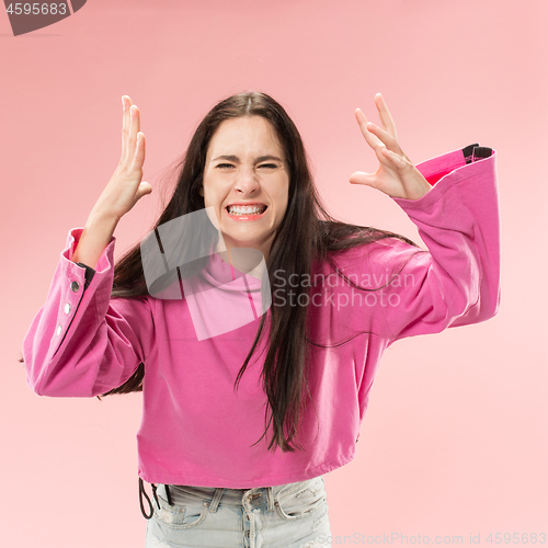 Image of Beautiful woman looking suprised and bewildered isolated on pink