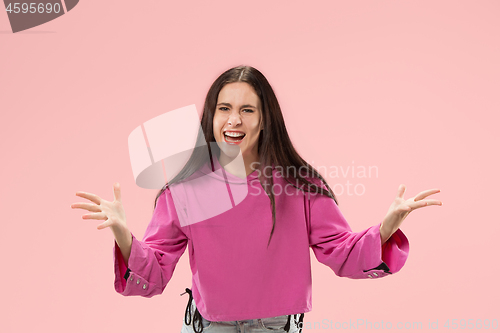 Image of Beautiful woman looking suprised and bewildered isolated on pink