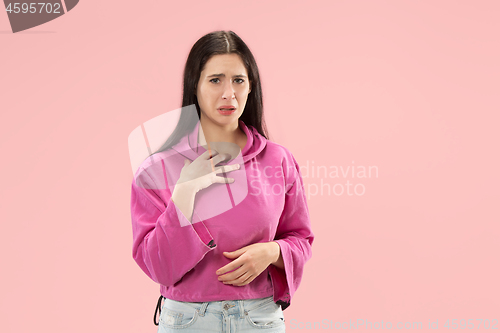 Image of Beautiful woman looking suprised and bewildered isolated on pink