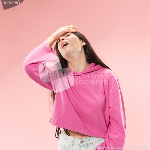 Image of Beautiful woman looking suprised and bewildered isolated on pink