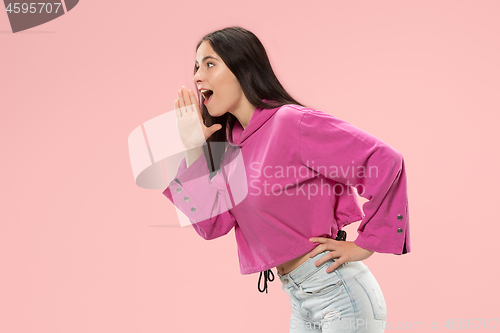 Image of Isolated on pink young casual woman shouting at studio