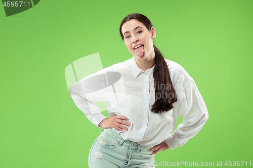 Image of The happy business woman standing and smiling against green background.