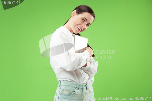 Image of Businesswoman hugging laptop. Love to computer concept.