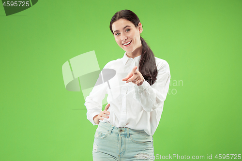 Image of The happy business woman point you and want you, half length closeup portrait on green background.