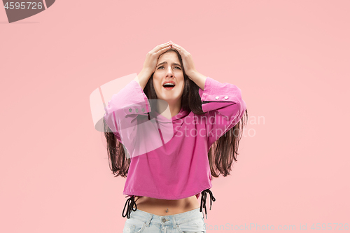 Image of Beautiful woman looking suprised and bewildered isolated on pink