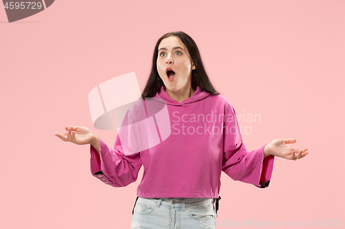 Image of Beautiful woman looking suprised isolated on pink