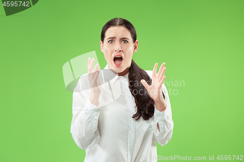 Image of Portrait of the scared woman on green