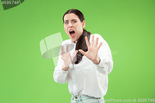 Image of Portrait of the scared woman on green