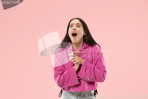 Image of Beautiful woman looking suprised isolated on pink