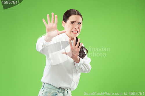 Image of Portrait of the scared woman on green