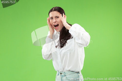 Image of Portrait of the scared woman on green