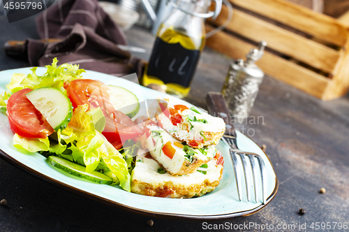 Image of omelette with vegetables on white plate