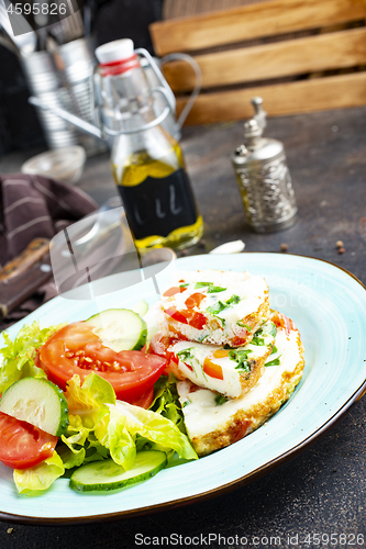 Image of omelette with vegetables on white plate