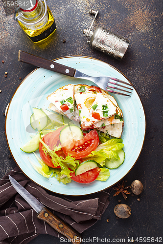 Image of omelette with vegetables on white plate