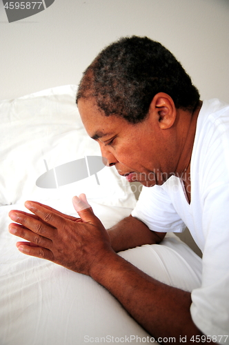 Image of African american male praying.