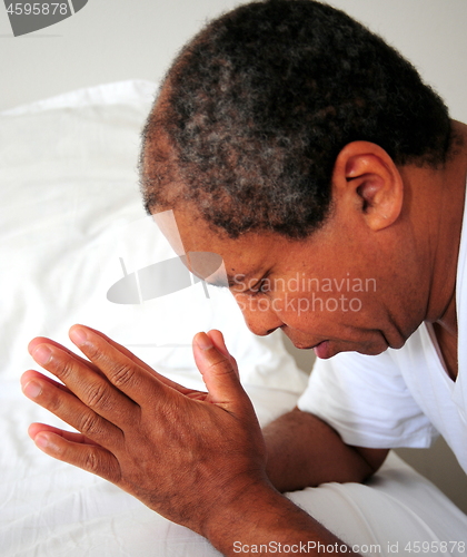 Image of African american male praying.