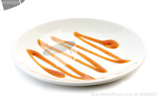 Image of caramel sauce on white plate