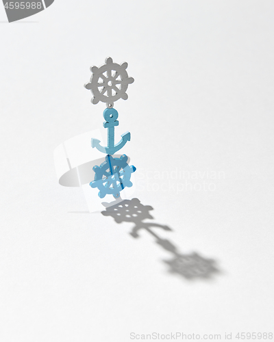 Image of Vertical stand from plastic anchor and wheels with shadows.